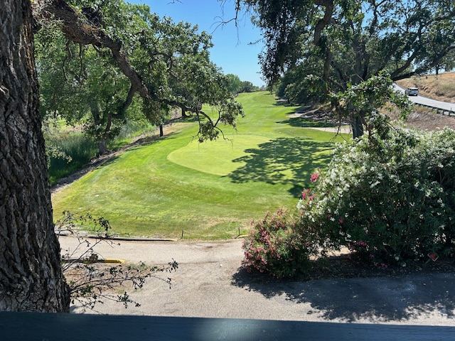 View of a golf green from the inn's grounds, bordered by oak trees