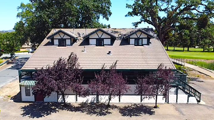 The 10th Green Inn, a three-story boutique inn with a Tudor-style roofline, seen from La Contenta Golf Club