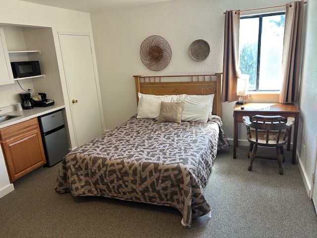 Room 23, a queen room with a kitchenette and writing desk