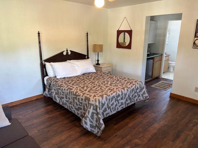 Room 36, a king room with wood floors and an adjoining kitchenette